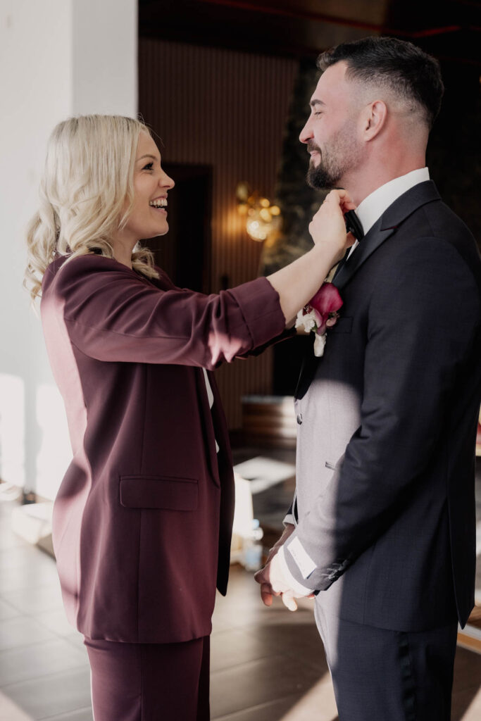 Destination wedding planner styling the groom during luxury wedding preparations
