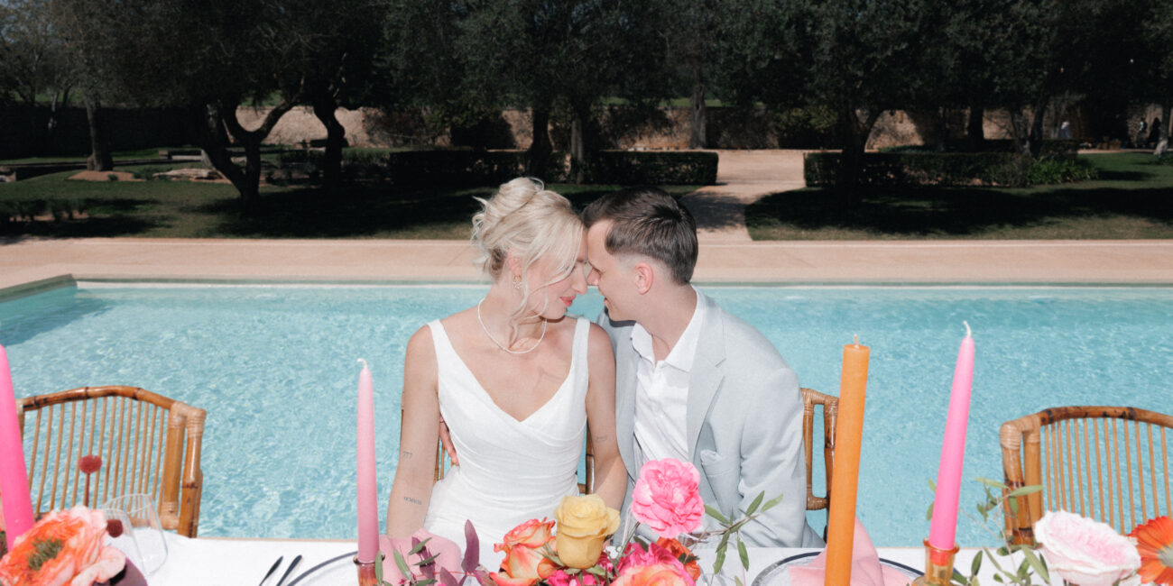 Bride and groom sitting at an elegant wedding table in Mallorca during a luxury destination wedding