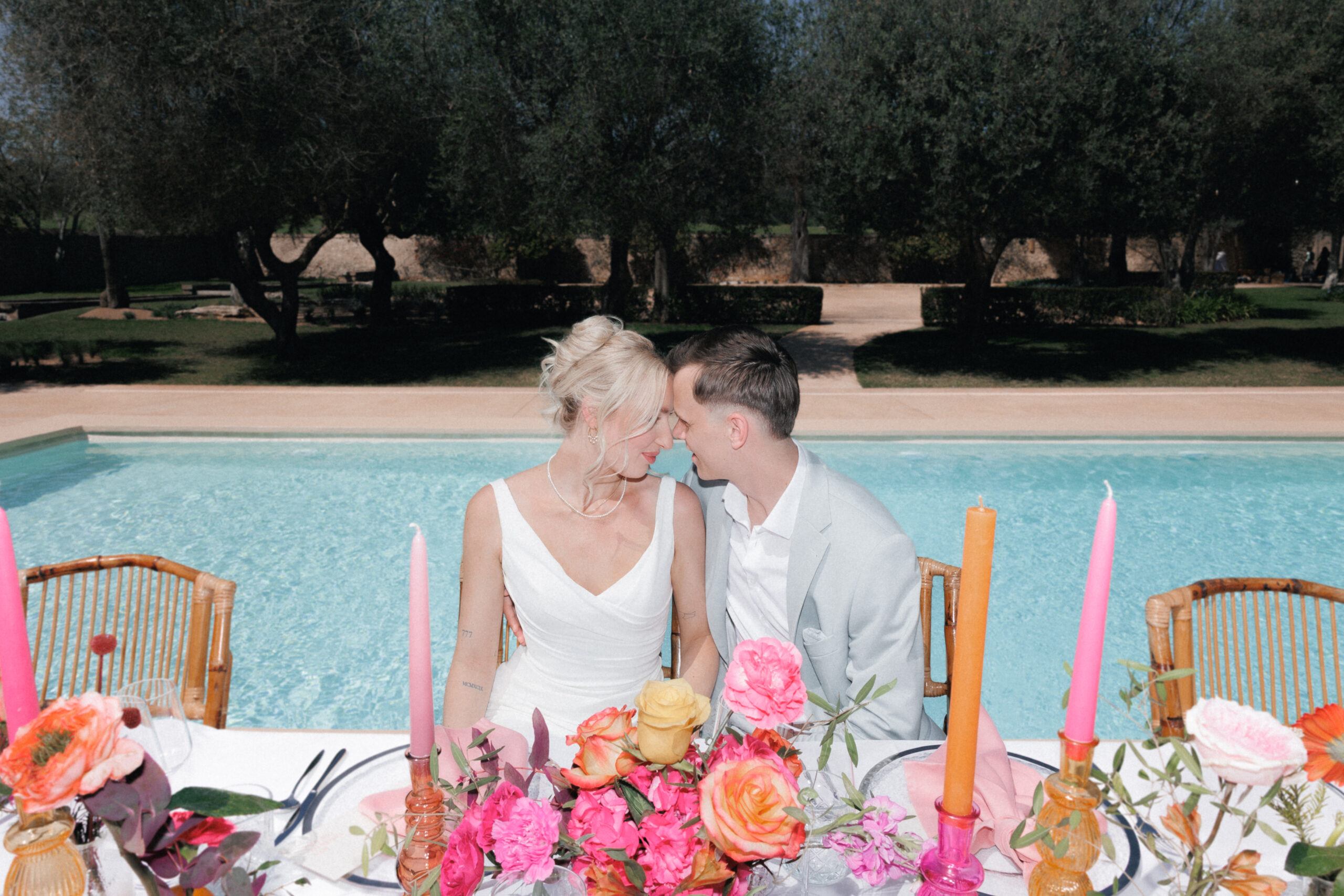 Bride and groom sitting at an elegant wedding table in Mallorca during a luxury destination wedding