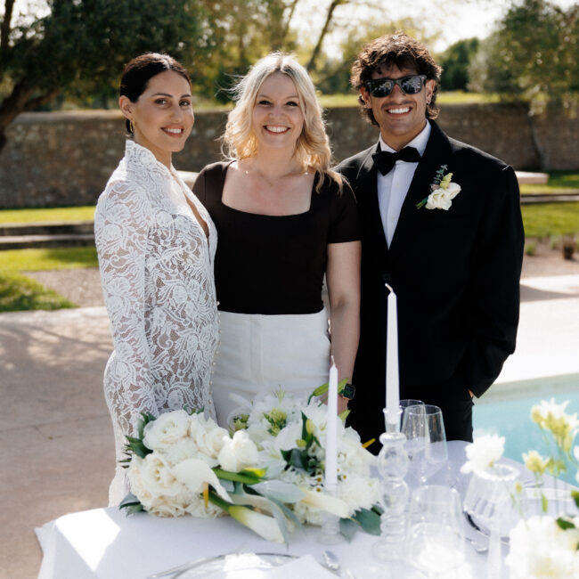 Bride and groom sitting at an elegant poolside wedding table in Mallorca during a luxury destination wedding