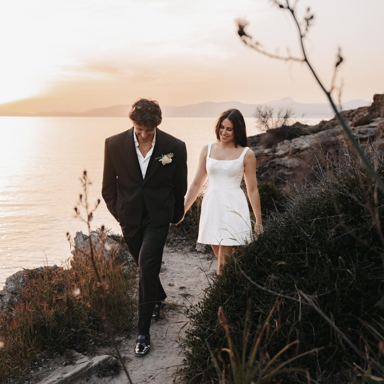 Emotional moment of a bride and groom at a beach in Europe, capturing timeless memories from their luxury destination wedding.