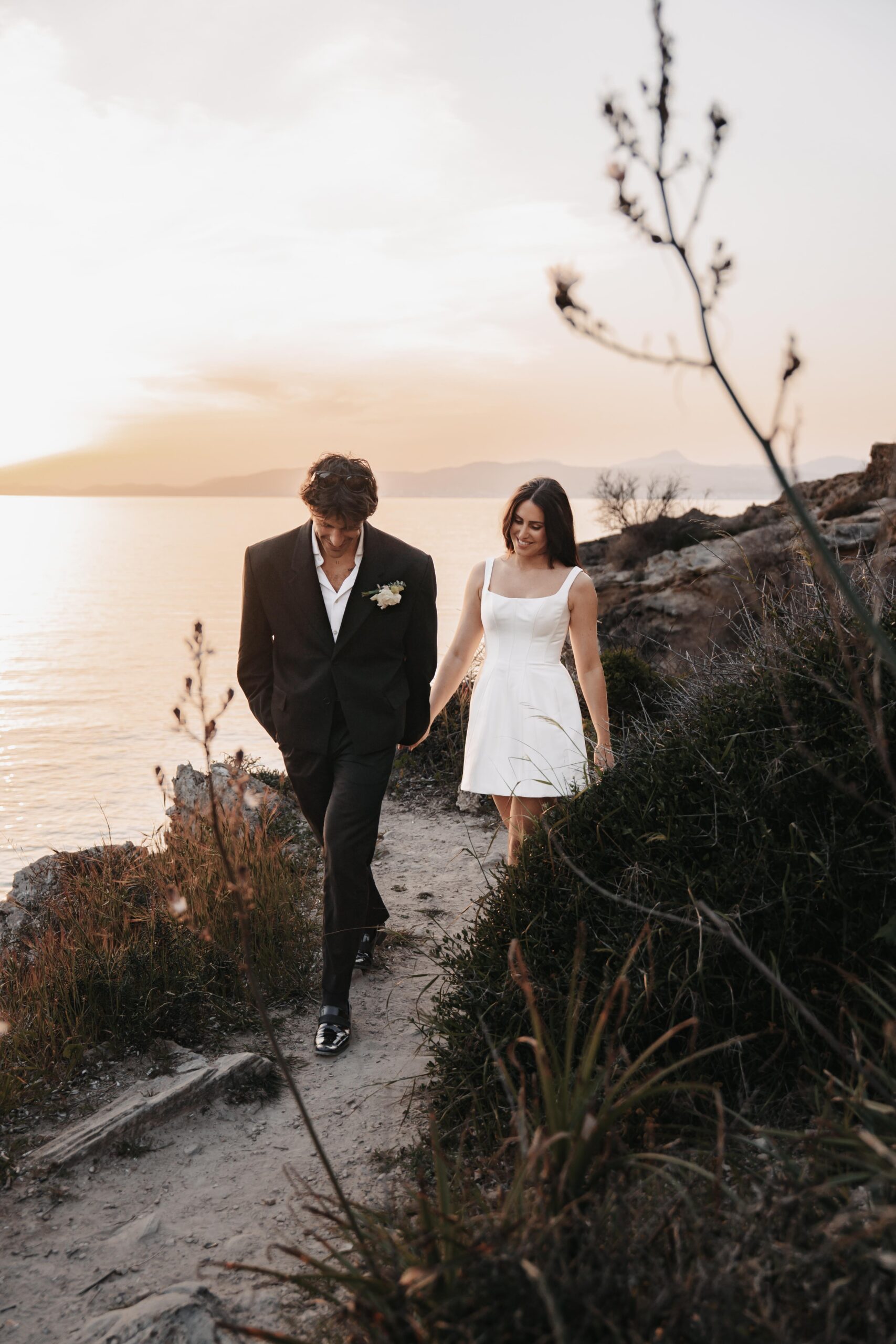 Emotional moment of a bride and groom at a beach in Europe, capturing timeless memories from their luxury destination wedding.