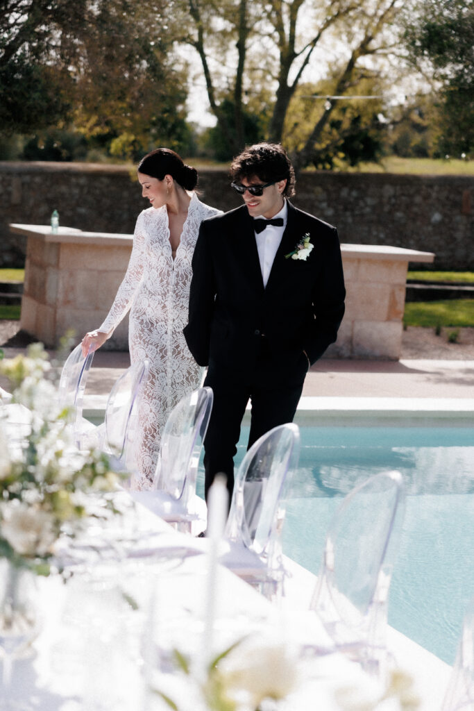 Bride and groom walking along a decorated wedding table during a luxury destination wedding in Europe.