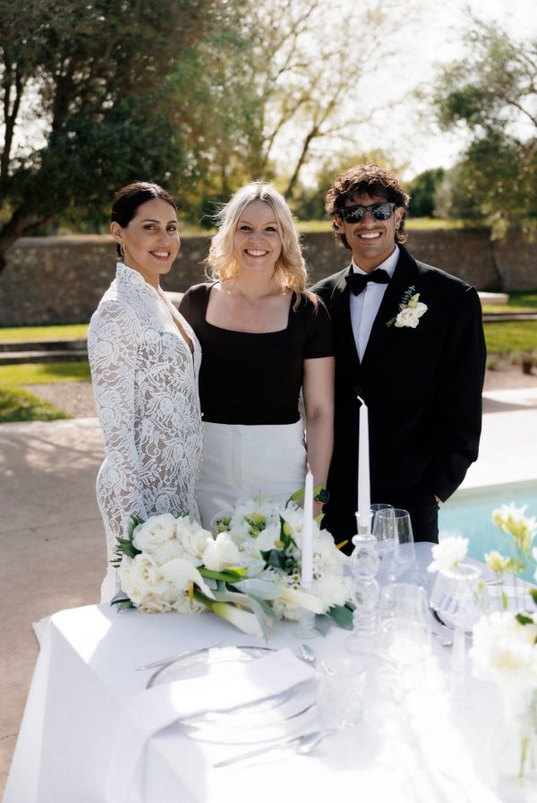 Bride and groom sitting at an elegant poolside wedding table in Mallorca during a luxury destination wedding